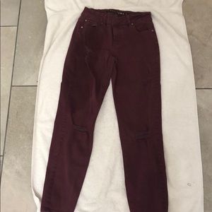Burgundy pants with string design at knee caps